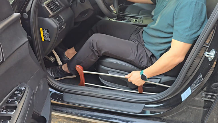 Stowing titanium crutches while sitting in the driver's seat