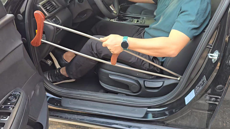 Stowing titanium crutches while sitting in the driver's seat